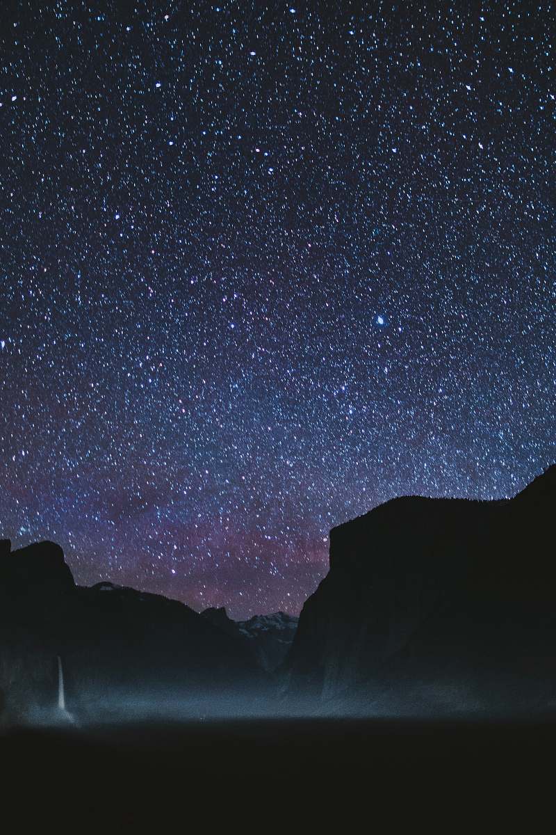 night silhouette of mountains during starry night astronomy
